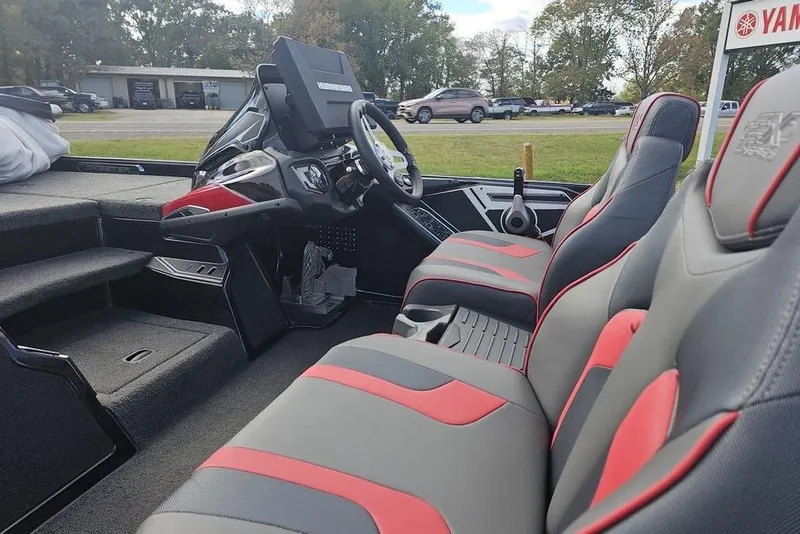 Slide: The Image of 2019 Skeeter FX21 boat interior with red and gray seats, steering console, and dashboard. - 5