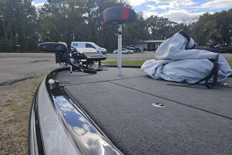 Slide: The Image of 2019 Skeeter FX21 boat deck with equipment and cover, parked outdoors. - 6