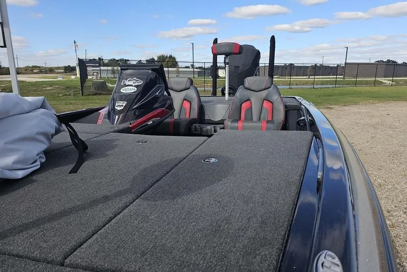 Slide: The Image of 2019 Skeeter FX21 bass boat with dual seats and spacious deck under a clear sky. - 7
