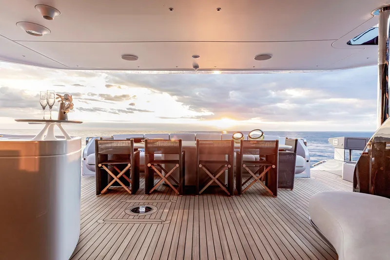 Slide: The Image of Luxury deck of 2024 Azimut Grande 36M yacht at sunset, featuring elegant seating and ocean view. - 14