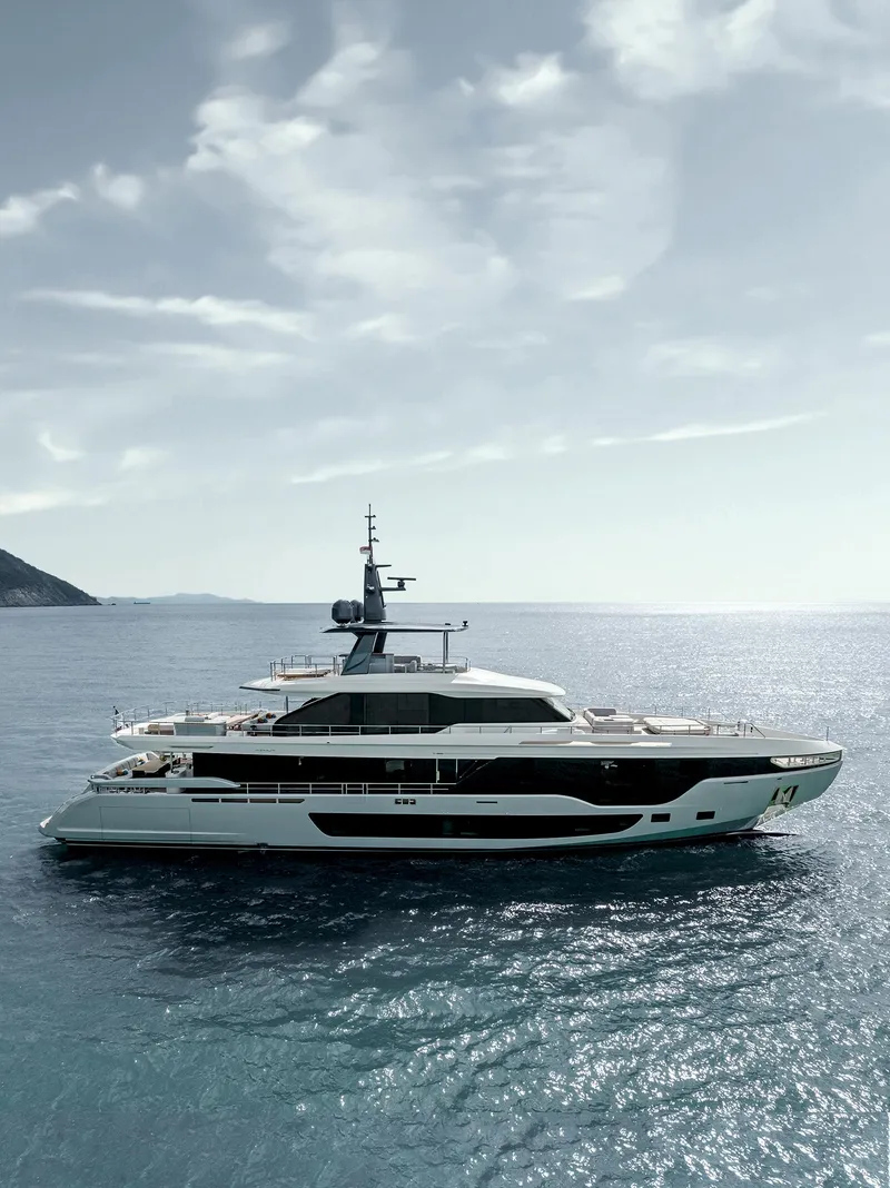 Slide: The Image of 2024 Azimut Grande 36M luxury yacht cruising on open sea under a cloudy sky. - 19