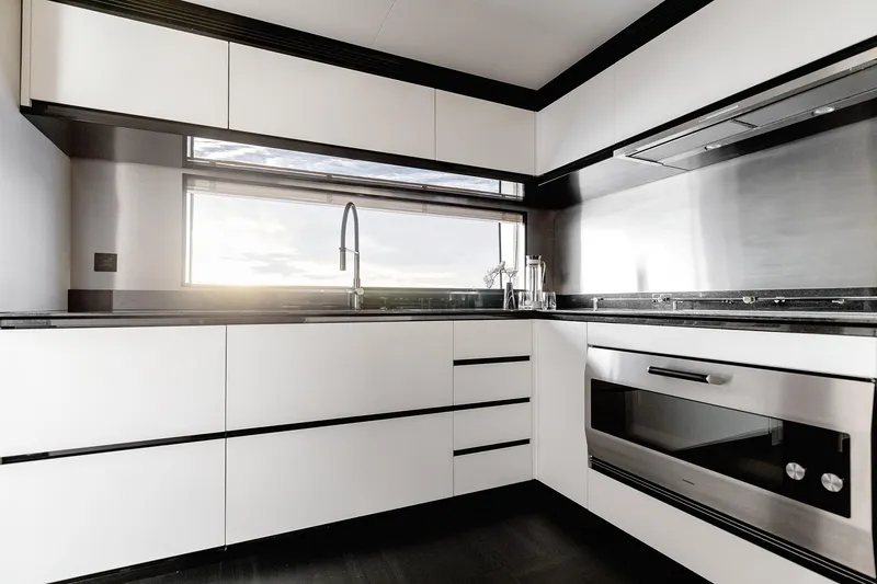Slide: The Image of Modern kitchen interior on 2024 Azimut Grande 36M yacht, featuring sleek cabinetry and stainless steel appliances. - 21