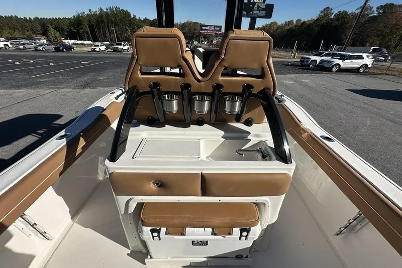 Slide: The Image of 2026 Key West 239 FSR boat interior with tan seating and modern console. - 10