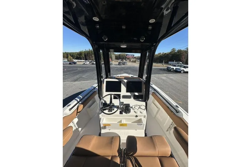 Slide: The Image of 2026 Key West 239 FSR boat with tan seating and sleek design. - 11