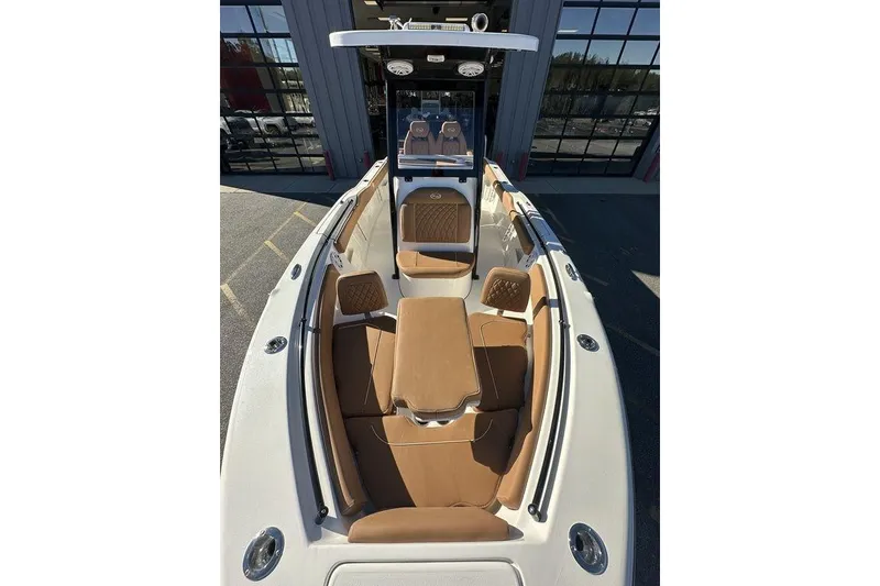 Slide: The Image of 2026 Key West 239 FSR boat interior with tan seating and cup holders. - 14