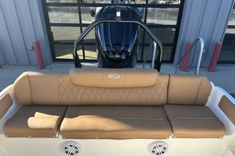 Slide: The Image of 2026 Key West 239 FSR boat interior with tan seats and modern console. - 2