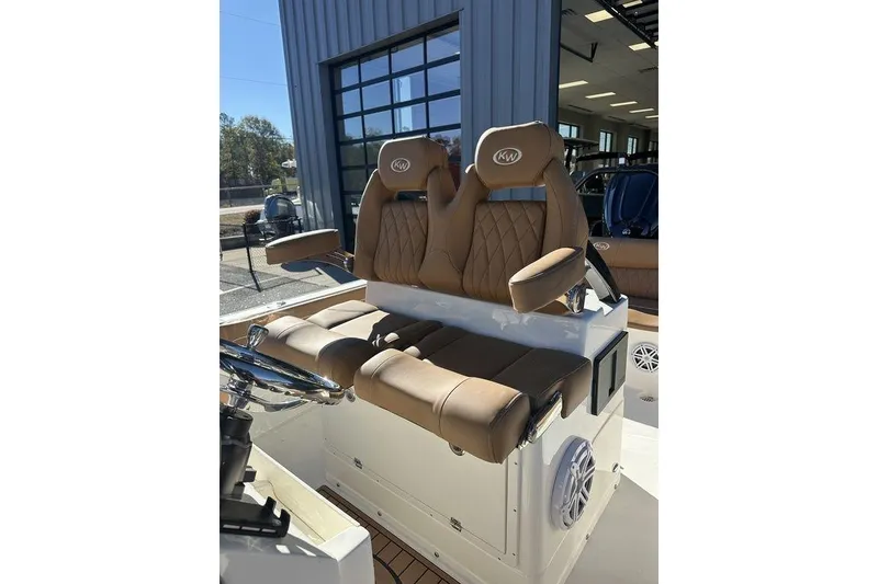 Slide: The Image of 2026 Key West 239 FSR boat dashboard with steering wheel and dual screens. - 4