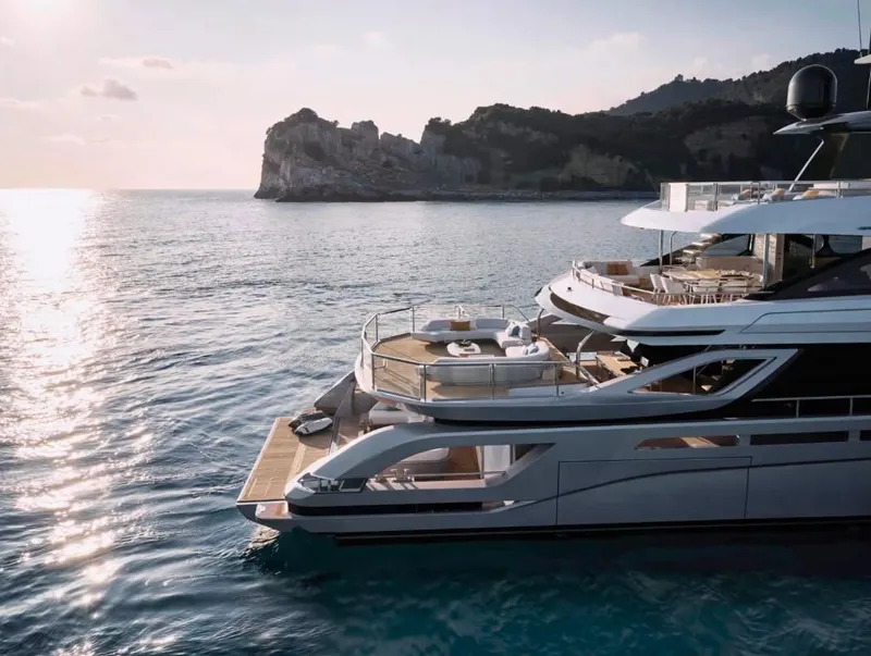 Slide: The Image of Luxurious 2027 Azimut 38M Grande Trideck yacht on serene ocean with scenic cliffs. - 4