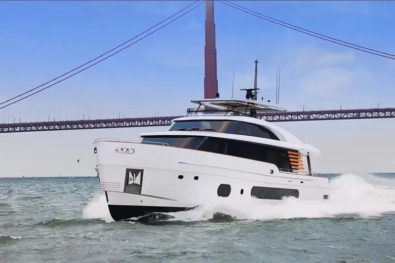 The Image of Luxury Azimut Grande Magellano 25 Metri yacht cruising under a bridge, 2026 model. - 0