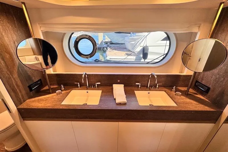 Slide: The Image of Luxurious bathroom in 2026 Azimut Grande Magellano 25 Metri yacht with dual sinks and porthole view. - 69