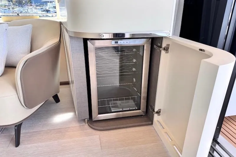 Slide: The Image of Luxury interior of 2026 Azimut Grande Magellano 25 Metri yacht with open mini fridge. - 87