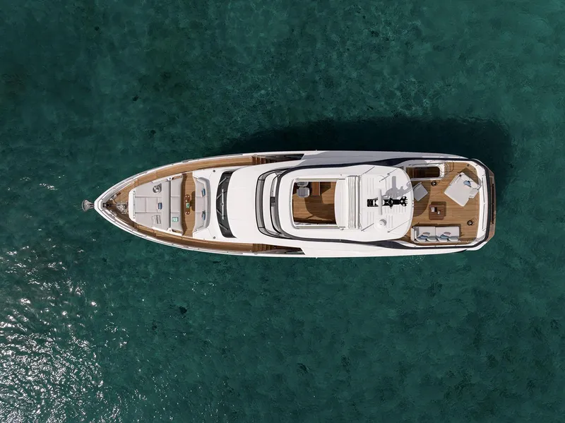 Slide: The Image of Aerial view of 2025 Azimut Grande 26M yacht on clear turquoise water. - 8