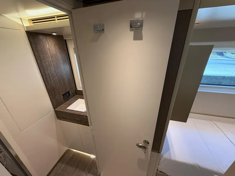 Slide: The Image of Interior of 2026 Azimut Magellano 25M yacht, featuring modern bathroom and bedroom design. - 14