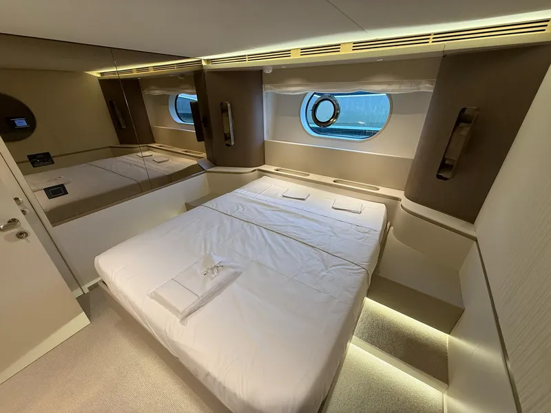 Slide: The Image of Luxurious bedroom interior of 2026 Azimut Magellano 25M yacht with modern design and porthole view. - 6