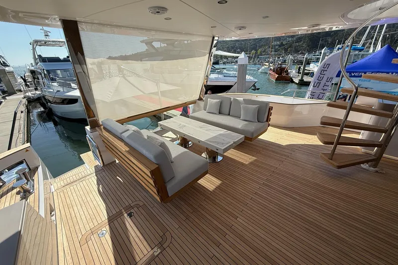 Slide: The Image of Luxurious 2026 Azimut Magellano 25M yacht deck with elegant seating and wooden flooring. - 99