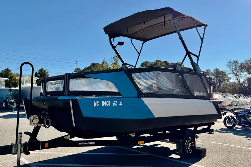 Slide: The Image of 2022 Seadoo Sport boat on trailer under clear blue sky. - 3