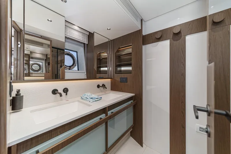 Slide: The Image of Luxurious bathroom interior of 2026 Azimut Fly 72 yacht with modern fixtures and wood accents. - 58