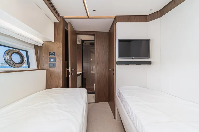 Slide: The Image of Luxurious interior of 2026 Azimut Fly 72 yacht with twin beds and modern amenities. - 69