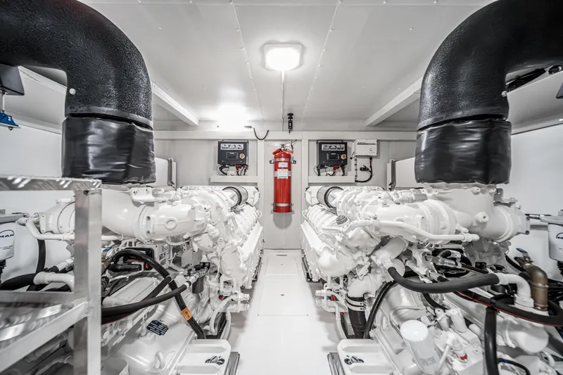Slide: The Image of Engine room of 2026 Azimut Fly 72 yacht, featuring dual engines and fire safety equipment. - 76