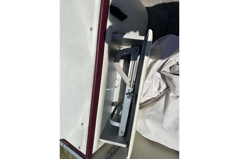 Slide: The Image of Storage compartment in a 1999 Crest 25 III Classic boat, featuring a folding mechanism. - 11