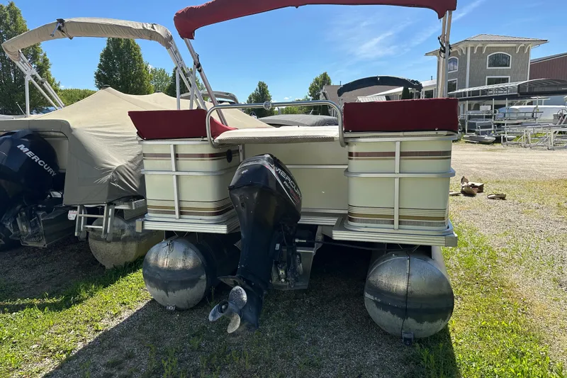 Slide: The Image of 1999 Crest 25 III Classic pontoon boat with Mercury outboard motor, parked outdoors. - 12