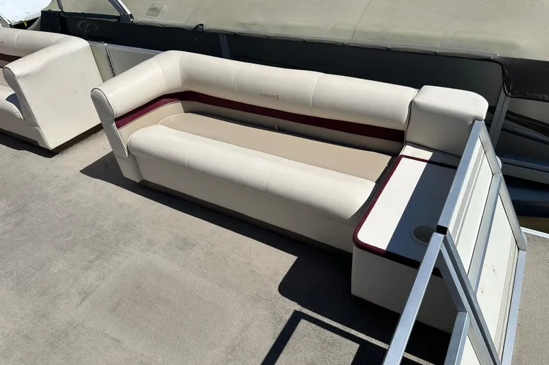 Slide: The Image of 1999 Crest 25 III Classic boat seating with beige upholstery and maroon accents. - 3