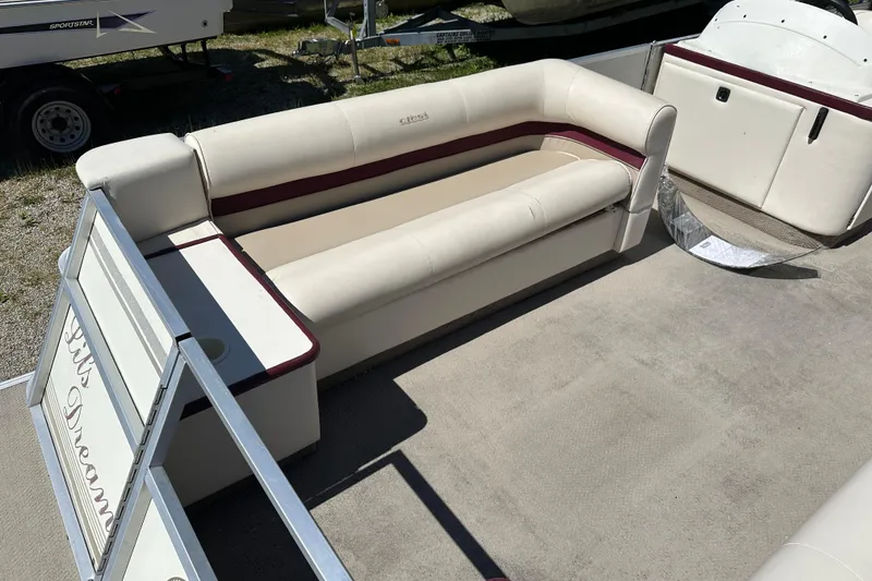 Slide: The Image of 1999 Crest 25 III Classic pontoon boat interior with beige seating and maroon accents. - 4