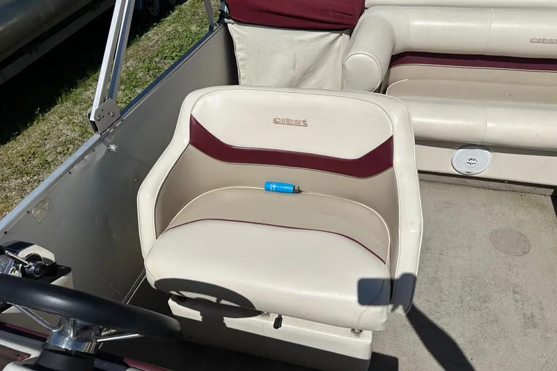 Slide: The Image of 1999 Crest 25 III Classic boat interior with beige and maroon seating. - 7