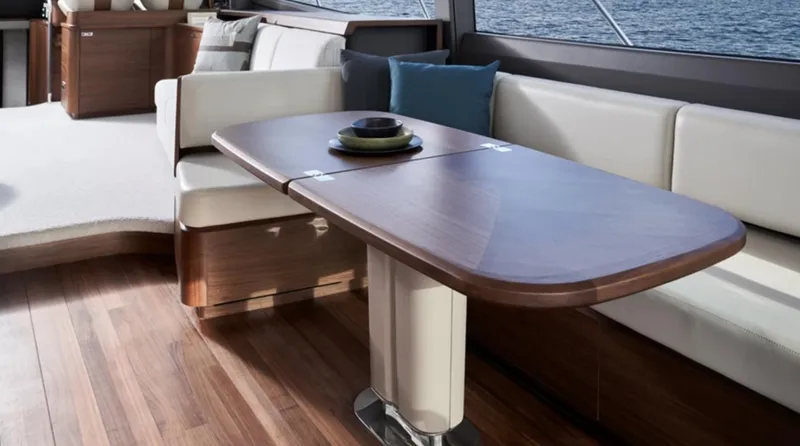 Slide: The Image of Luxurious interior of 2025 Princess F65 yacht with elegant wood table and plush seating. - 12