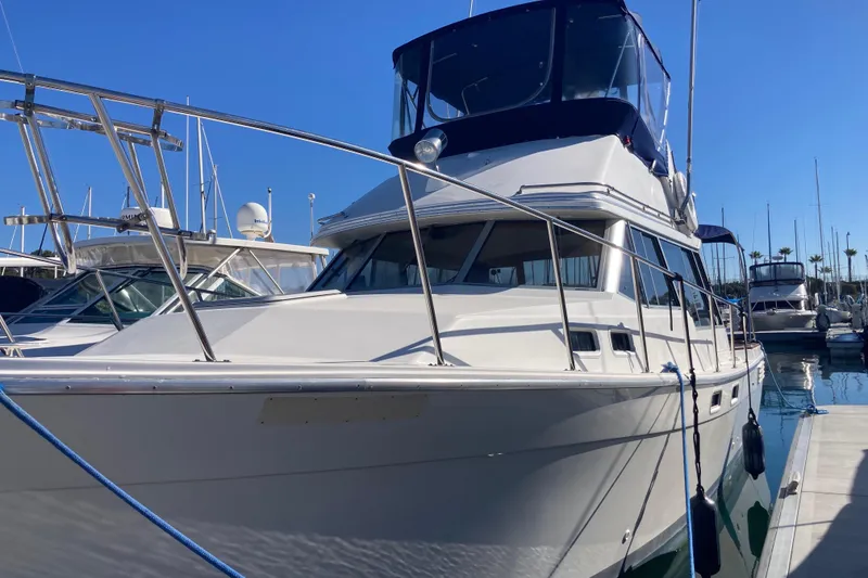 The Image of 1989 Bayliner 3288 Motoryacht docked at marina under clear blue sky. - 0