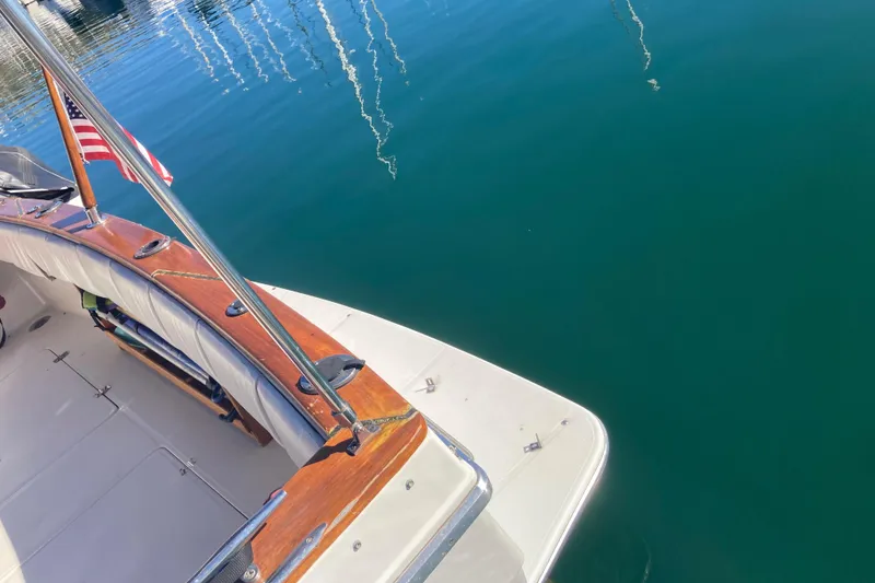 Slide: The Image of 1989 Bayliner 3288 Motoryacht deck with American flag, docked in marina. - 11
