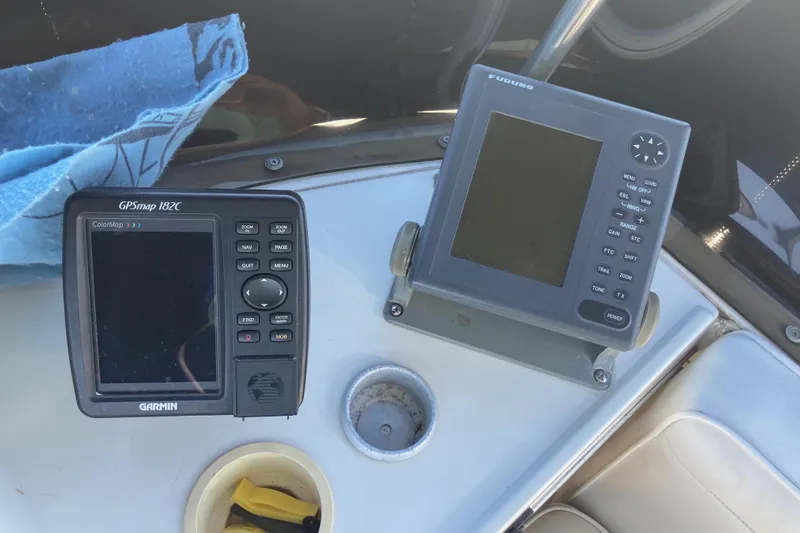 Slide: The Image of 1989 Bayliner 3288 Motoryacht helm with steering wheel, gauges, and navigation equipment. - 14