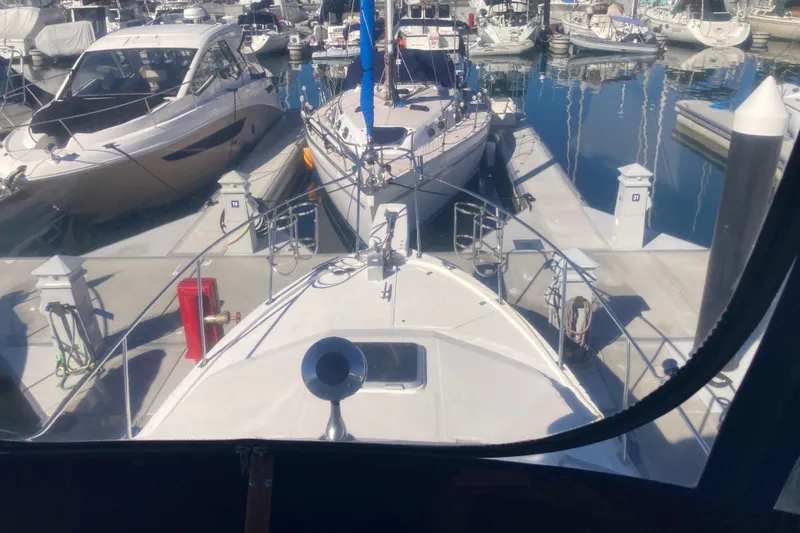 Slide: The Image of 1989 Bayliner 3288 Motoryacht interior with white seating and clear canopy. - 19