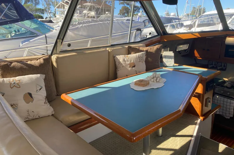 Slide: The Image of 1989 Bayliner 3288 Motoryacht docked at a marina, surrounded by other boats. - 20