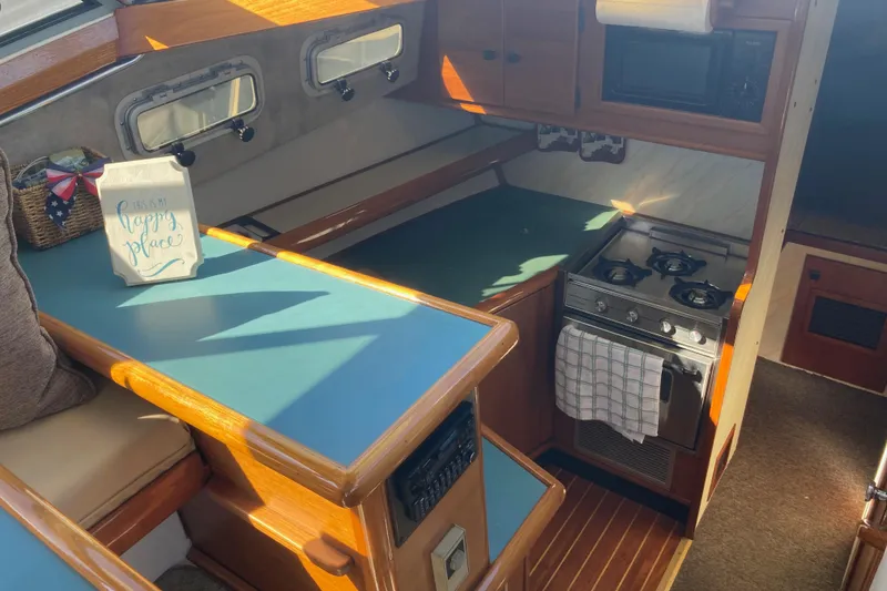 Slide: The Image of Interior view of 1989 Bayliner 3288 Motoryacht with marina backdrop. - 23