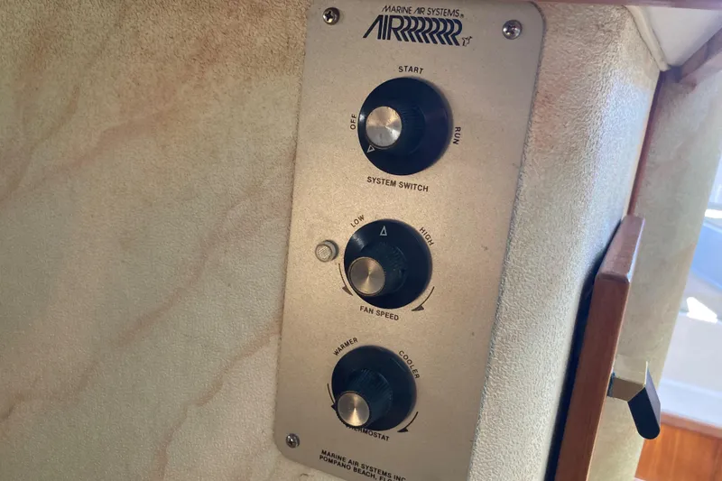 Slide: The Image of 1989 Bayliner 3288 Motoryacht interior with books, hat, and control panel. - 34