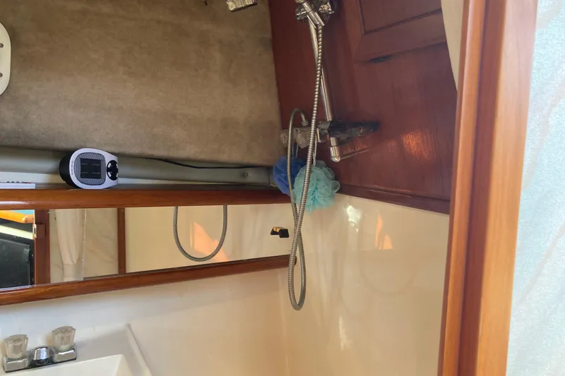 Slide: The Image of 1989 Bayliner 3288 Motoryacht bathroom with sink, mirror, and wooden accents. - 36