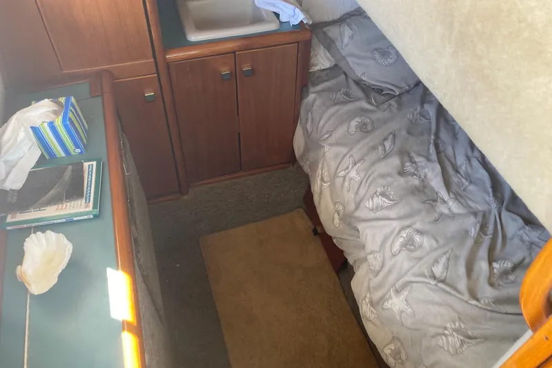 Slide: The Image of 1989 Bayliner 3288 Motoryacht interior with wooden cabinetry and sink area. - 39