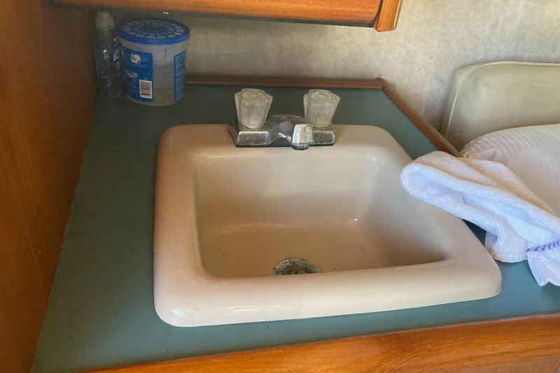 Slide: The Image of Cozy cabin interior of 1989 Bayliner 3288 Motoryacht with seashell-themed bedding. - 41