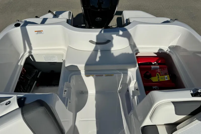 Slide: The Image of 2025 Bayliner Element E16 boat interior with storage compartments and seating. - 16