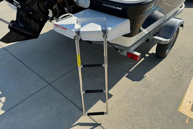 Slide: The Image of 2025 Bayliner Element E16 boat with extended swim ladder on trailer. - 19