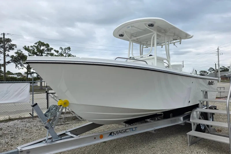 Slide: The Image of 2026 Parker 230 Coastal Elite boat on trailer, displayed outdoors under cloudy sky. - 15
