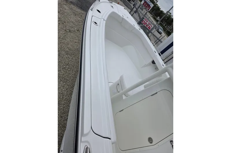 Slide: The Image of 2026 Parker 230 Coastal Elite boat, white interior, docked outdoors. - 16
