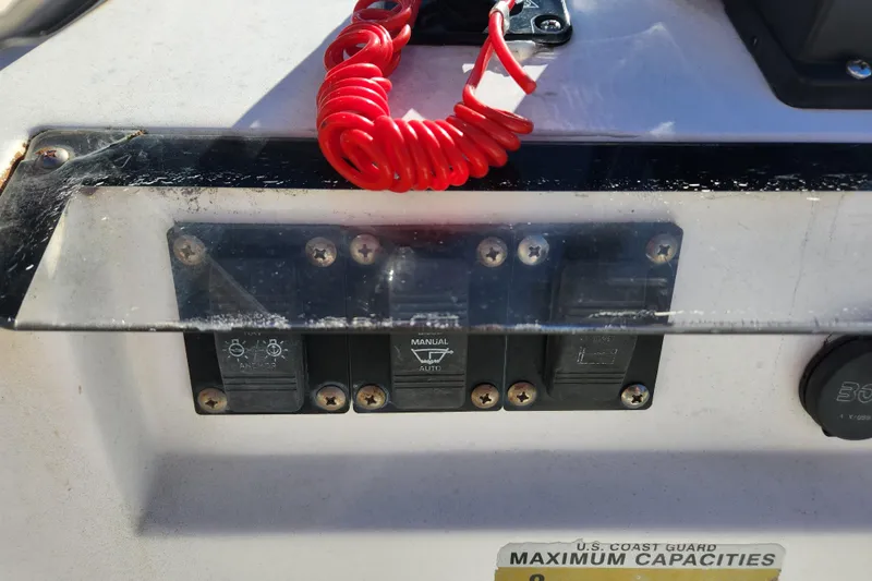 Slide: The Image of Control panel of a 2003 McKee Craft 185 Offshoreman boat with red safety cord. - 10
