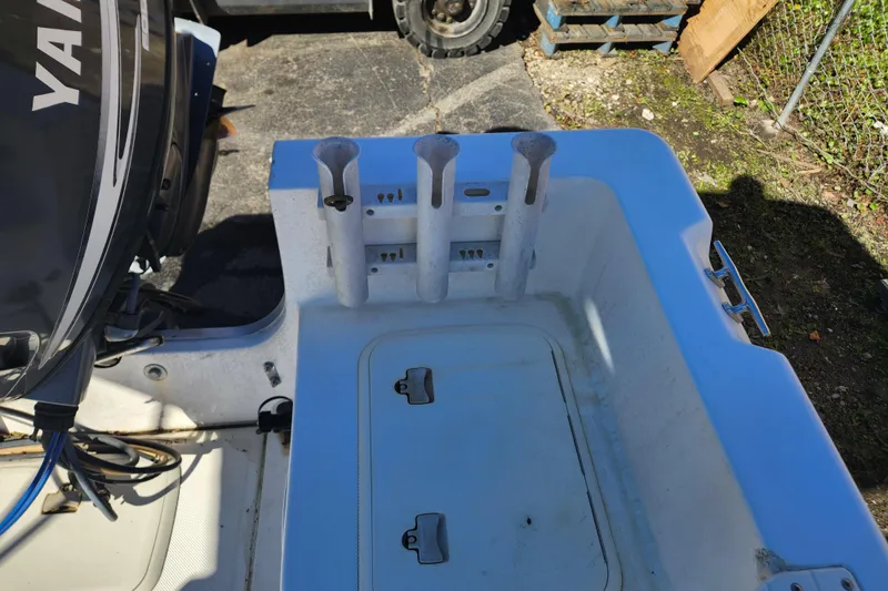 Slide: The Image of 2003 McKee Craft 185 Offshoreman boat with rod holders and storage compartment. - 12