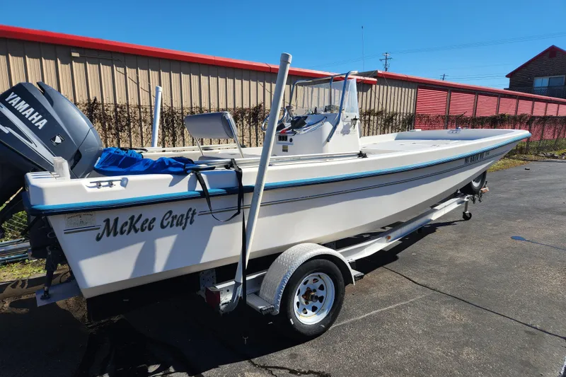 Slide: The Image of 2003 McKee Craft 185 Offshoreman boat on trailer, featuring Yamaha outboard motor. - 2