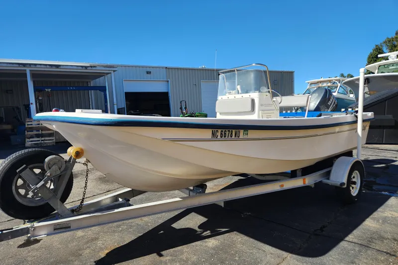 Slide: The Image of 2003 McKee Craft 185 Offshoreman boat on trailer, parked outside a warehouse. - 3