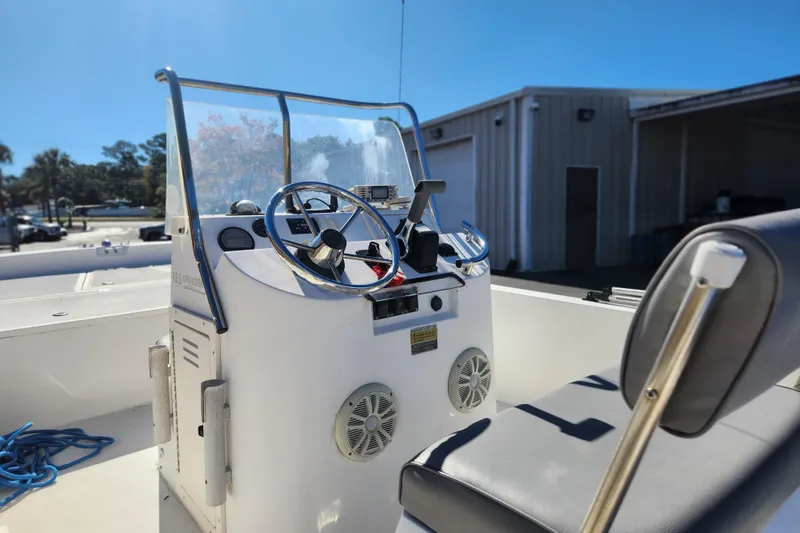 Slide: The Image of 2003 McKee Craft 185 Offshoreman boat console with steering wheel and seating. - 9