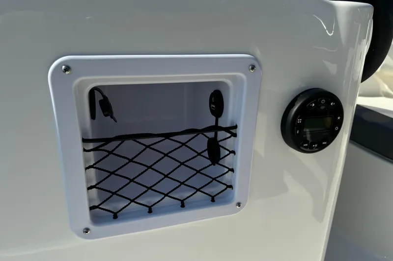 Slide: The Image of 2025 Bayliner Element E16 boat dashboard with storage compartment and control panel. - 14