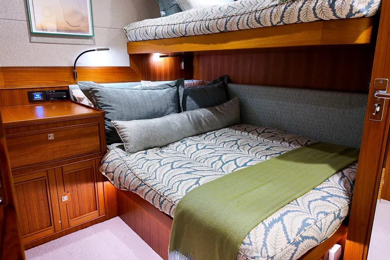 Slide: The Image of Luxurious 2022 Marlow Voyager yacht docked by palm trees and waterfront homes. - 2